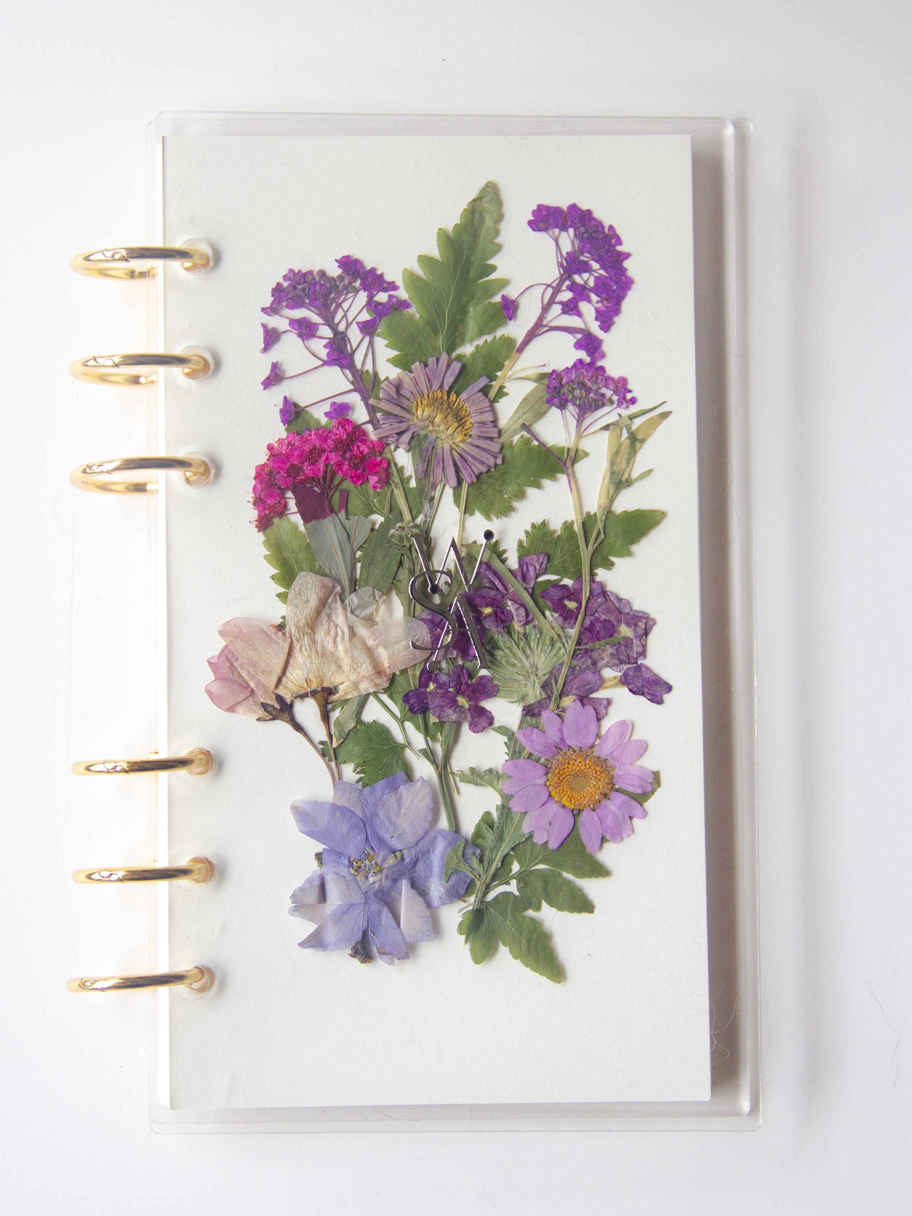 Planner cover with pressed flowers on a white background